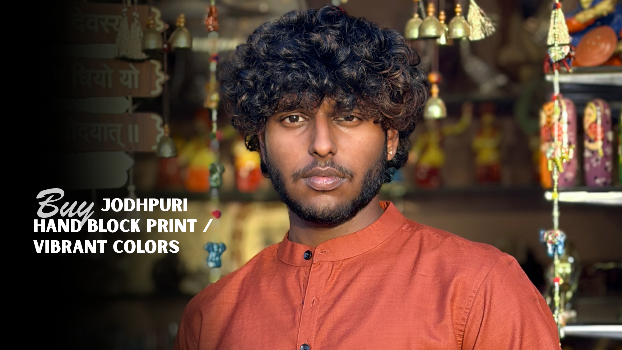 Man wearing an orange shirt with text promoting Jodhpuri hand block print clothing.